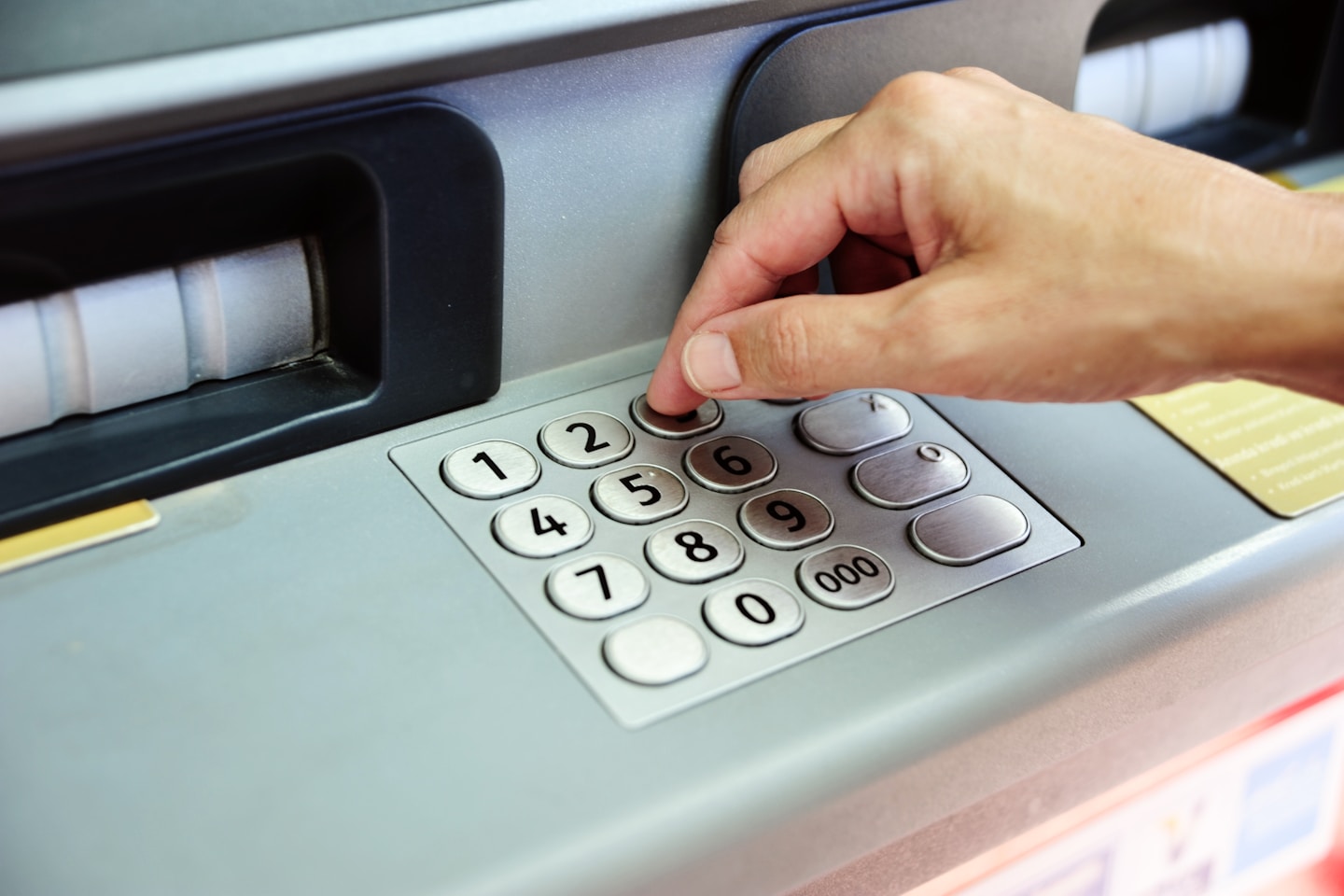 Woman is taking cash from atm