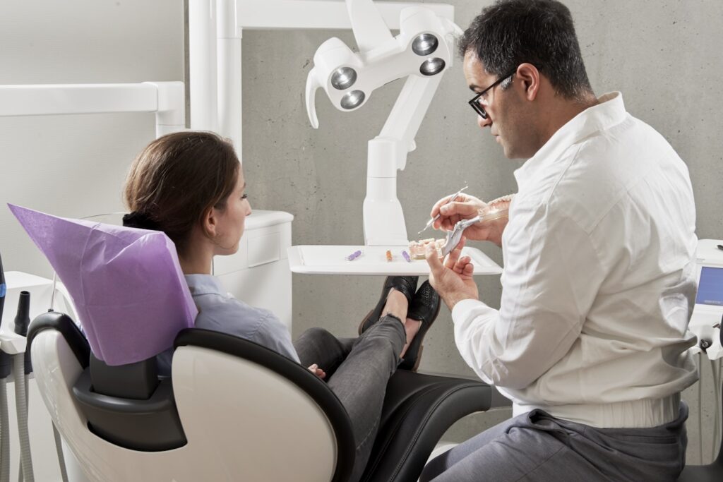 man in white dress shirt sitting on black office rolling chair