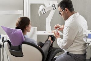 man in white dress shirt sitting on black office rolling chair
